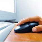 A hand on a computer mouse