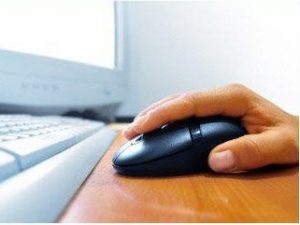Person's hand on a computer mouse